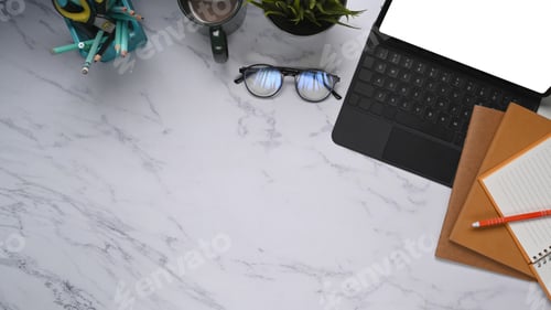 Preview: Top view of modern and stylish workplace with tablet, glasses, notebook on marble.
