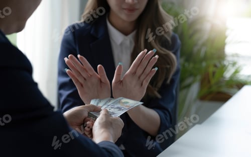 Preview: A professional Asian female lawyer or business legal consultant refuses a bribe or money from her