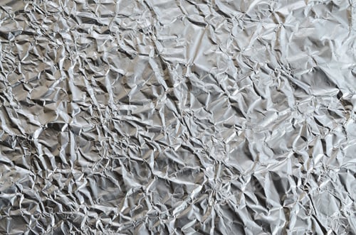 Preview: Thin wrinkled sheet of crushed tin aluminum silver foil background with shiny crumpled