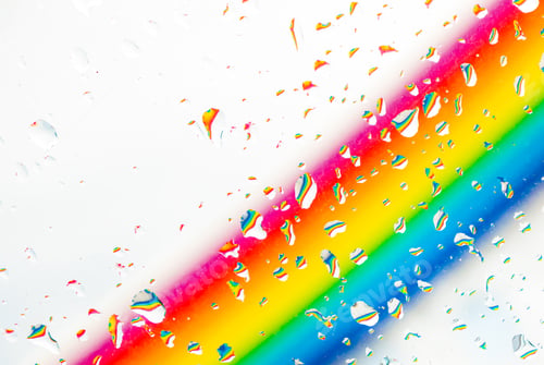 Preview: A rainbow behind a glass windows with water drops, Point of view, from behind the glass with drops.