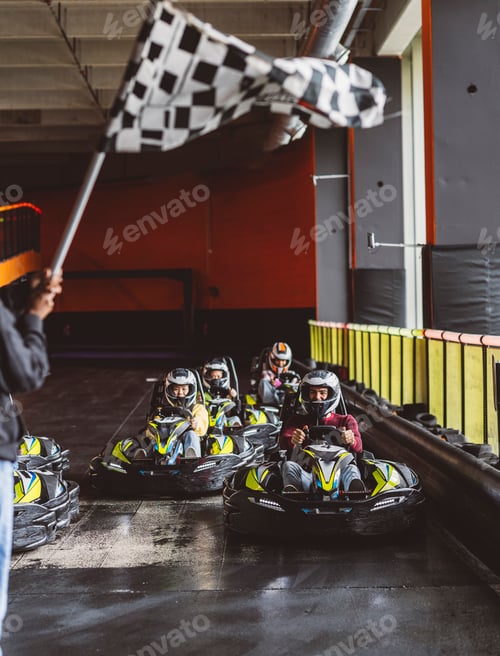 Preview: Go-Kart Racers Drive starting flag group of young people generation z driving