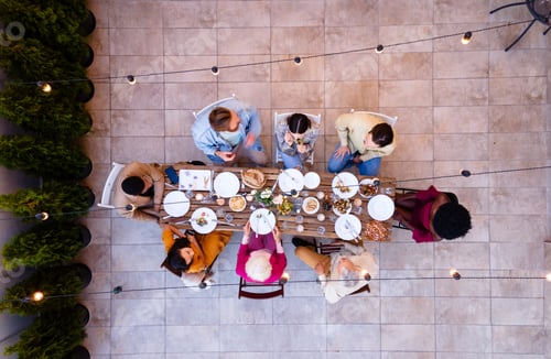 Preview: Family and friends celebrating at dinner on a rooftop terrace