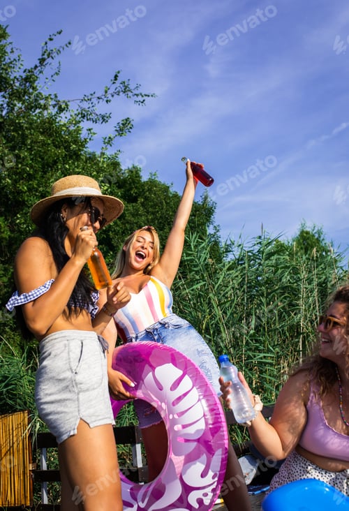 Preview: Group of female friends enjoying a summer day at the lake.