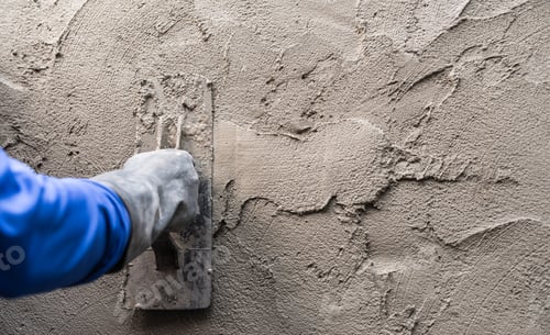 Preview: Hand plasterer plastering cement wall background, hand worker brush rough concrete floor for smooth