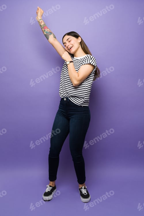 Preview: Full length of an attractive woman playing karaoke