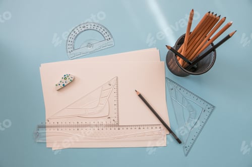 Preview: measuring and drawing tools. A sheet of white paper, pencils, rulers on the desktop. Empty space for
