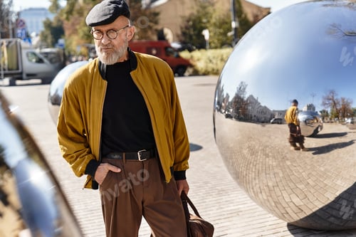 Preview: A senior man strolls confidently through a cityscape, complemented by shiny modern sculptures.
