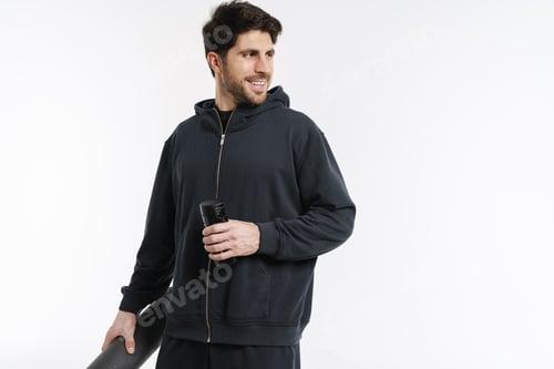 Preview: Smiling athletic sportsman posing with fitness mat and water bottle