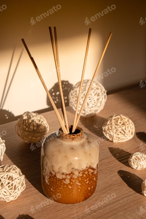 Preview: Cozy home decorations aroma reed diffuser in the living room. Home comfort concept. Bottle container