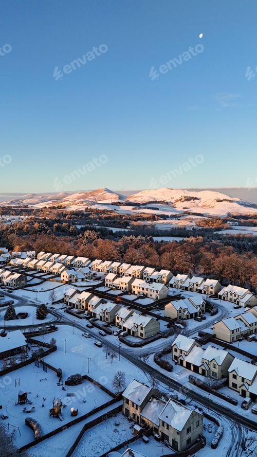 Preview: Snowy suburban neighborhood with distant hills.