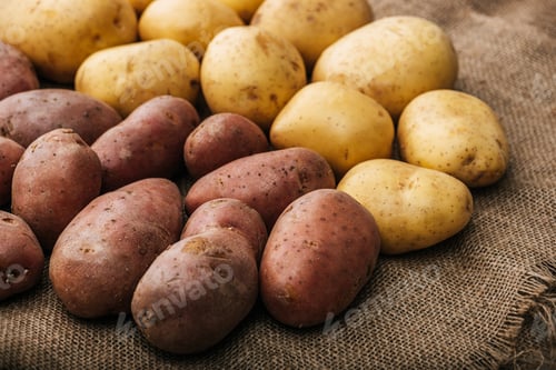 Preview: organic raw potatoes on brown rustic sackcloth