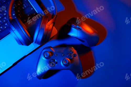 Preview: Headphones, joystick and computer keyboard on black table