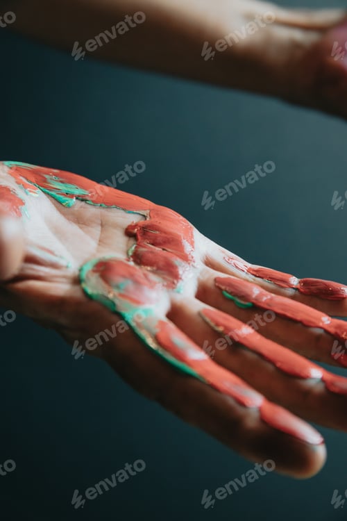 Preview: Fun leisure. Creative female artist showing hands dirty with different colors paint