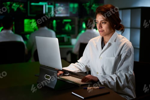 Preview: Female Medical Research Scientist using computer laptop. Neurologist Solving Puzzles of the Mind