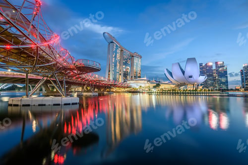 Preview: Illuminated Singapore waterfront in the evening, with Marina Bay Sands Hotel and ArtScience Museum.