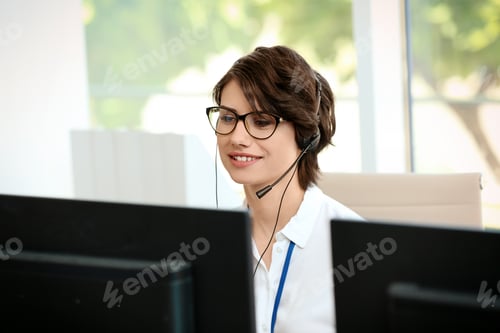 Preview: Female technical support operator with headset at workplace