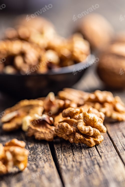 Preview: Peeled dried walnut kernels on wooden table.