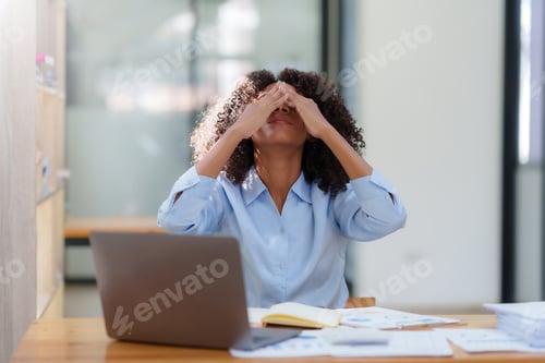 Preview: Businesswoman stressed with overwork in the office.