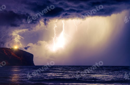 Preview: Stormy weather, thunder and forked lightning bolts over sea and headland at night