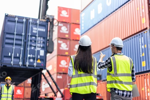 Preview: Caucasian business man and woman worker working in container terminal.