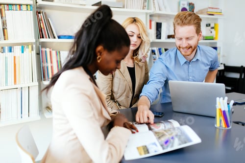 Preview: Business people brainstorming in office at desk