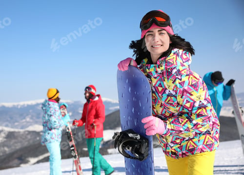 Preview: Young woman with snowboard at ski resort, space for text. Winter vacation