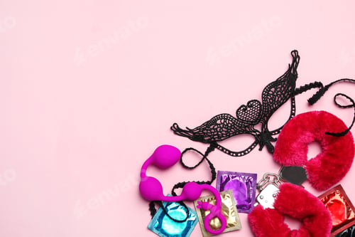 Preview: Different sex toys on pink background, flat lay. Space for text