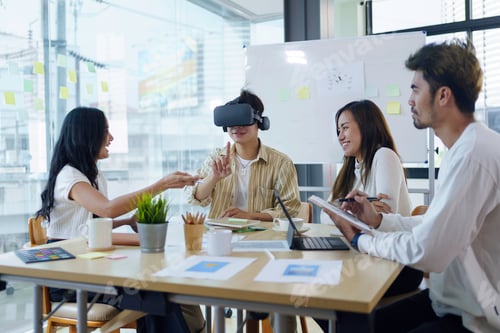 Preview: Group of young entrepreneur in Asia used virtual reality glasses during the conference to test