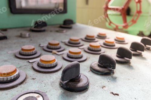 Preview: Selective focus shot of an old dusted control panel with manual knobs