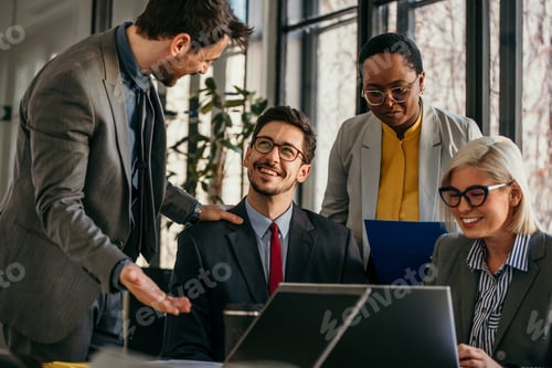 Preview: Business team discussing work on laptop in office meeting