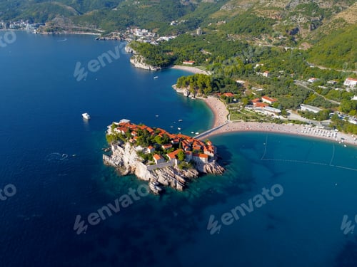 Preview: Aerial view of Sveti Stefan island and shore in a beautiful summer day, Montenegro from flying drone