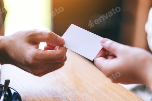 Preview: Two businessman holding and exchanging empty business card