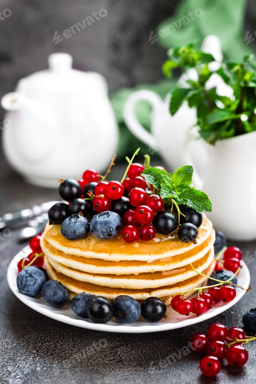 Preview: Pancakes with fresh berries. Pancakes with raspberry, blueberry, redcurrant, black currant and honey