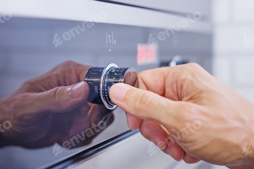 Preview: Man hand setting cooking mode on electrical oven