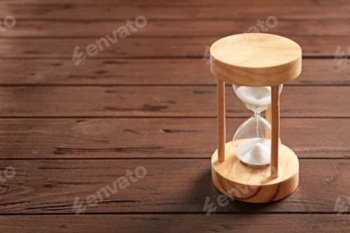 Preview: Hourglass with flowing sand on table. Time management