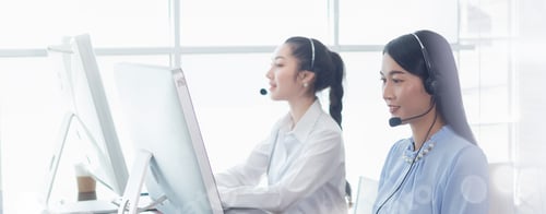 Preview: Woman operators team with microphone and computer at work.