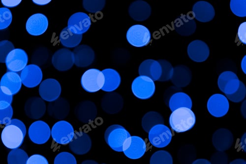 Preview: Unfocused abstract colourful bokeh black background. defocused and blurred many round blue light