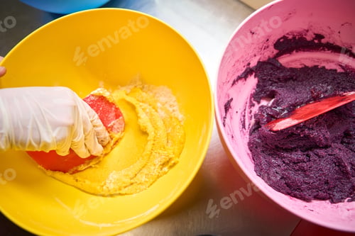 Preview: Experienced pastry cook busy with macaronaging on kitchen table