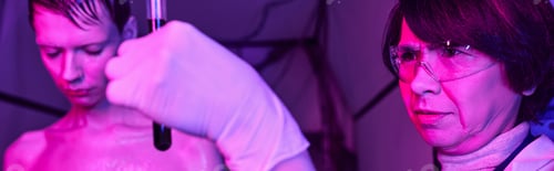 Preview: woman scientist holding test tube with blood sample near extraterrestrial in science center, banner
