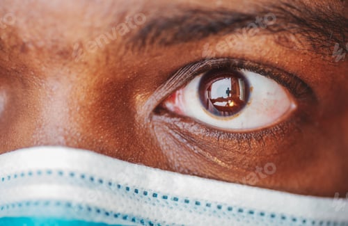 Preview: Close-up of African-American men’s brown eyes wearing blue face mask