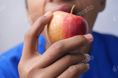 Preview: child boy eating apple close up