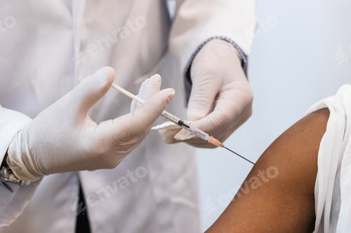 Preview: Doctor making injection for black woman patient
