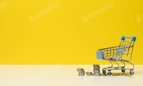 Preview: Metal trolley and small change on a white table. Savings concept, discounts, low purchasing power