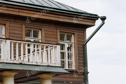 Preview: Rustic Two-Story Wooden House with Classic White Balcony
