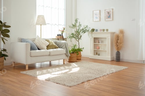 Preview: Cozy Living Room Featuring a Light Couch and Indoor Plants in a Sunlit Space With Wooden Floors