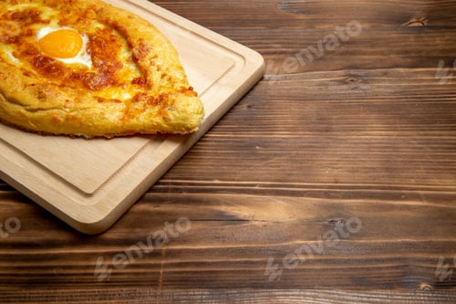 Preview: front view baked bread with cooked egg on wooden desk bread bun food egg breakfast dough