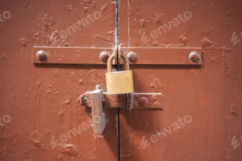 Preview: Wooden brown door background locked with two padlocks. Aged entrance, close up view with details.