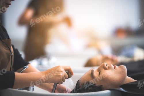 Preview: hairdresser washing client's hair at salon. happy customer relax and comfortable while washing hair