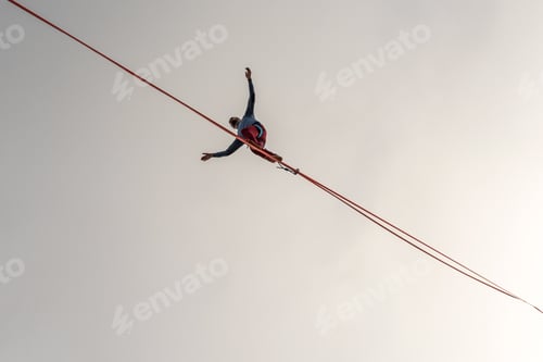 Preview: A man balancing on a tight rope.
