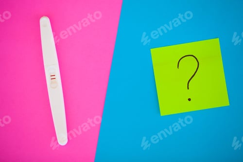 Preview: Close up of pregnancy test and contraceptive pills birth control concept on blue background